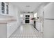 Kitchen area with white cabinets and appliances at 5319 Eagles Nest Rd, Fruitland Park, FL 34731