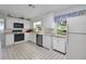 Bright kitchen featuring white appliances and cabinets at 5319 Eagles Nest Rd, Fruitland Park, FL 34731