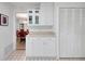 Bright kitchen with tiled floors, white cabinets, and a view to the dining room at 5319 Eagles Nest Rd, Fruitland Park, FL 34731