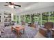 Spacious sunroom with comfortable seating, bright natural light, and views of the lush backyard at 5319 Eagles Nest Rd, Fruitland Park, FL 34731