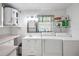 Functional laundry room with a utility sink, storage, and included washer and dryer at 5319 Eagles Nest Rd, Fruitland Park, FL 34731