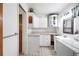Laundry room with utility sink, cabinets and countertop area, with a stacked washer and dryer at 5319 Eagles Nest Rd, Fruitland Park, FL 34731