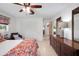 Comfortable bedroom with a dresser and closet space, featuring bright windows and a ceiling fan at 5319 Eagles Nest Rd, Fruitland Park, FL 34731