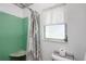 Neat shower room with green ceramic tile, shower curtain, and a toilet at 5319 Eagles Nest Rd, Fruitland Park, FL 34731