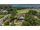 Aerial view of the house with a lake in the background, surrounded by trees at 622 W 11Th Ave, Mount Dora, FL 32757