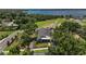 Aerial view of the house with a lake in the background, surrounded by trees at 622 W 11Th Ave, Mount Dora, FL 32757