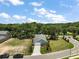 Aerial shot of the property showing a landscaped front yard and a paved driveway at 622 W 11Th Ave, Mount Dora, FL 32757