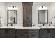 Elegant bathroom offers double sinks with dark wood cabinets and stylish lighting fixtures at 622 W 11Th Ave, Mount Dora, FL 32757