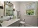 Stylish bathroom featuring gray vanity, a large mirror, white shiplap, and a garden window with natural light at 622 W 11Th Ave, Mount Dora, FL 32757
