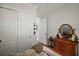 Bright bedroom features an oval wooden mirror, neutral walls and trim, and a built-in closet with white doors at 622 W 11Th Ave, Mount Dora, FL 32757