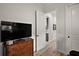Bright bedroom with a TV on a dresser and a doorway leading to the kitchen and bathroom at 622 W 11Th Ave, Mount Dora, FL 32757