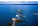 Aerial view of a dock with boats on a tranquil lake at dusk at 622 W 11Th Ave, Mount Dora, FL 32757