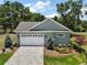 Aerial view of a well-maintained home featuring a two-car garage and a paved driveway at 622 W 11Th Ave, Mount Dora, FL 32757