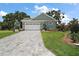 Charming single-story home with a well-manicured lawn and a spacious driveway at 622 W 11Th Ave, Mount Dora, FL 32757