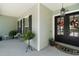 Charming front porch with double doors, green siding, and a hanging lantern at 622 W 11Th Ave, Mount Dora, FL 32757