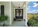 Inviting covered porch featuring stylish double doors, green siding, and a view at 622 W 11Th Ave, Mount Dora, FL 32757