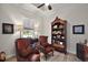 Cozy home office features a window, two upholstered chairs, a bookshelf, and neutral paint at 622 W 11Th Ave, Mount Dora, FL 32757
