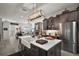 Kitchen with eat-in island, stainless appliances, and view into the open concept living area at 622 W 11Th Ave, Mount Dora, FL 32757