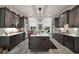 Kitchen with center island, stainless steel appliances, and modern pendant lighting at 622 W 11Th Ave, Mount Dora, FL 32757