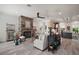 Bright living room with stone fireplace, ceiling fan, and view into the kitchen at 622 W 11Th Ave, Mount Dora, FL 32757