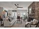 Inviting living room featuring a stone fireplace, wood floors and a large ceiling fan at 622 W 11Th Ave, Mount Dora, FL 32757