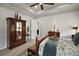 Sophisticated main bedroom features a decorative armoire, tray ceiling, and an antique wooden bed with stylish bedding at 622 W 11Th Ave, Mount Dora, FL 32757