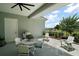 Inviting covered patio featuring white Adirondack chairs, a grill, a dining table set for six, and neutral paint at 622 W 11Th Ave, Mount Dora, FL 32757