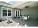 Inviting covered patio featuring white Adirondack chairs, a dining table set for six, and neutral paint at 622 W 11Th Ave, Mount Dora, FL 32757