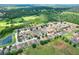 Scenic aerial shot of community with pond and mature trees, home location is indicated by a red arrow at 6906 Glenbrook Dr, Lakeland, FL 33811