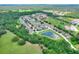 Beautiful aerial view of community featuring mature trees and pond with home marked by red arrow at 6906 Glenbrook Dr, Lakeland, FL 33811