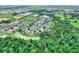 Lush aerial of neighborhood featuring mature trees, serene pond and home with location indicated with a red arrow at 6906 Glenbrook Dr, Lakeland, FL 33811