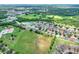Aerial image of home near other residential homes, green space, and a small body of water at 6906 Glenbrook Dr, Lakeland, FL 33811
