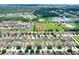 Aerial view of house in residential area near a large grassy field and multiple other homes at 6906 Glenbrook Dr, Lakeland, FL 33811