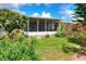 Cozy screened lanai overlooking lush, landscaped backyard perfect for relaxing and outdoor enjoyment at 6906 Glenbrook Dr, Lakeland, FL 33811