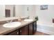 Bathroom featuring double sinks and a separate bathtub at 6906 Glenbrook Dr, Lakeland, FL 33811