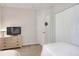 Neutral bedroom with twin beds, dresser and closet. A door is seen to bathroom at 6906 Glenbrook Dr, Lakeland, FL 33811