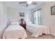 Bright bedroom featuring two twin beds and soft, neutral decor at 6906 Glenbrook Dr, Lakeland, FL 33811
