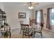 Cozy dining area featuring a glass table, decorative accents, and natural light from the nearby window at 6906 Glenbrook Dr, Lakeland, FL 33811