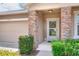 Welcoming front exterior with stone accents, landscaped yard, and attached two-car garage at 6906 Glenbrook Dr, Lakeland, FL 33811