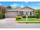 Charming single-story home featuring stone accents, landscaped front yard, and two-car garage at 6906 Glenbrook Dr, Lakeland, FL 33811