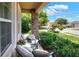 Inviting front porch with stone pillars, comfortable seating, and lush greenery at 6906 Glenbrook Dr, Lakeland, FL 33811