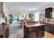 Modern kitchen with dark cabinets, breakfast bar, and seamless flow into the living area at 6906 Glenbrook Dr, Lakeland, FL 33811