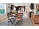 Open-concept kitchen and dining area with modern appliances, dark cabinets, and warm lighting at 6906 Glenbrook Dr, Lakeland, FL 33811