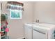 Modern laundry room with front-load washer and dryer at 6906 Glenbrook Dr, Lakeland, FL 33811