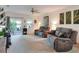Comfortable living room featuring plush couches and a sliding glass door leading to outdoor patio at 6906 Glenbrook Dr, Lakeland, FL 33811