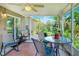 Cozy sunroom with chairs and an inviting view of the colorful garden at 6906 Glenbrook Dr, Lakeland, FL 33811