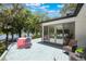 Back deck with view of the water, seating area, and sliding door entry to home at 7921 Sebago Ct, Orlando, FL 32835