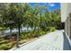 Back deck features a scenic view of the water surrounded by mature trees and lush landscaping at 7921 Sebago Ct, Orlando, FL 32835