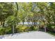 Scenic backyard view of water surrounded by mature trees and lush landscaping from back deck at 7921 Sebago Ct, Orlando, FL 32835