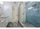 Bathroom with modern fixtures and a walk-in glass shower with blue tiled surround at 7921 Sebago Ct, Orlando, FL 32835